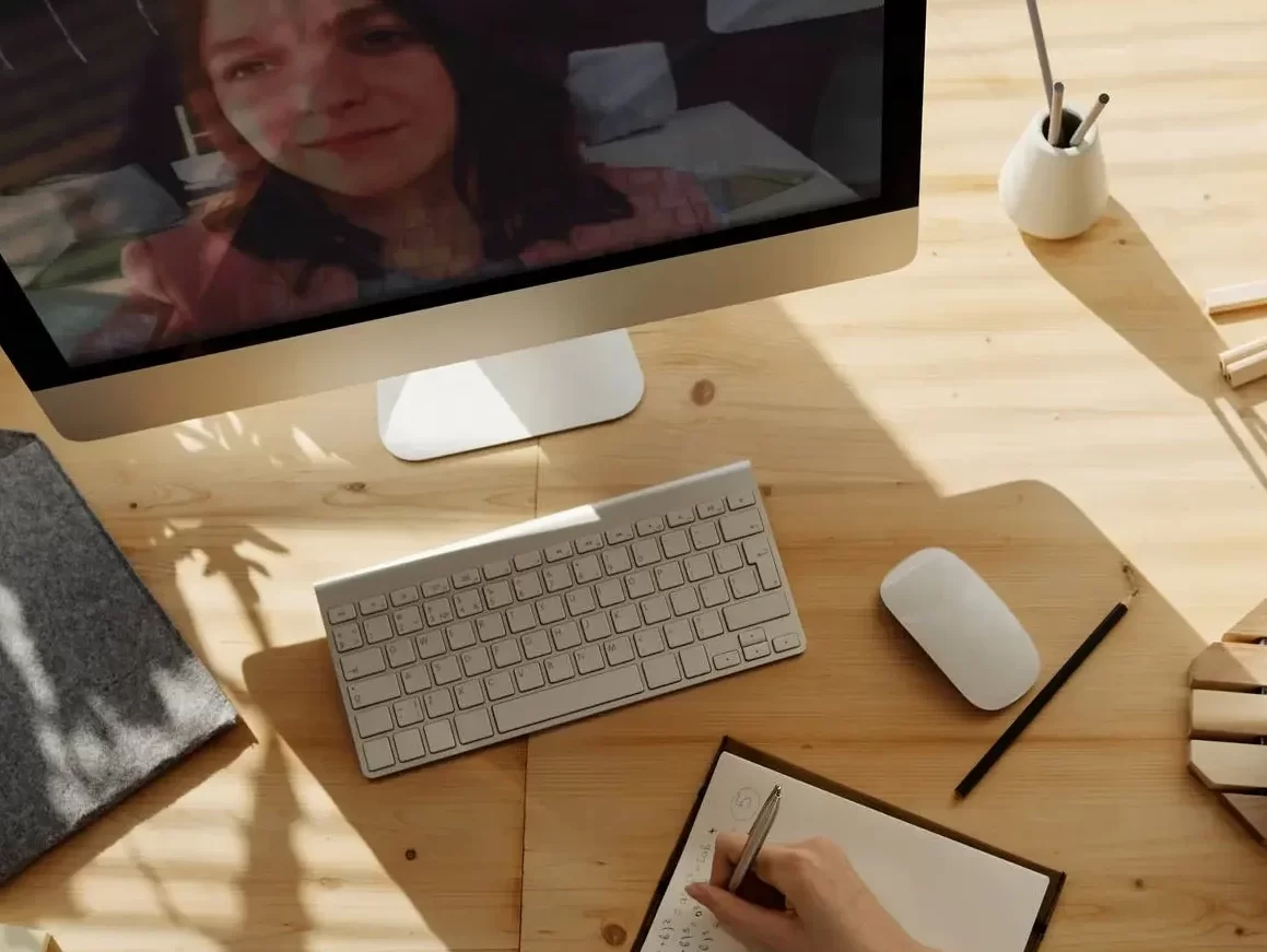 person writing on notebook